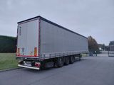 a semi truck that is driving down the road
