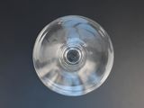 a glass of wine on a table with a blue background
