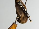 a bagpipe that is flying through the air with a hat on it
