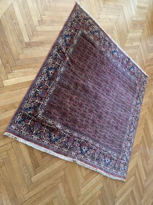 rug on the floor of a room with a wooden floor