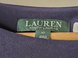 a close up of a purple shirt with a green label on it