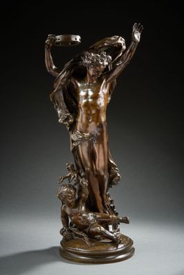 a bronze statue of a man holding a bird in his hand