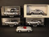three boxed silver cars are sitting on display in a box