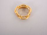 a close up of a gold ring on a white surface