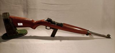 an old rifle with a wooden barrel and a wooden stand