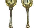 pair of silver spoons on a white background with a white background