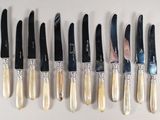eight knives that are lined up in a row