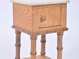 a small wooden table with a marble top on it