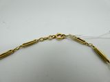 a close up of a gold necklace with a long chain