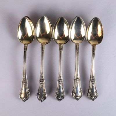 six spoons are lined up in a row on a white surface