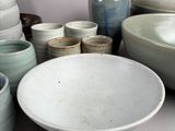 many bowls and bowls that are sitting on a table