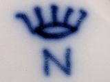 a blue and white plate with a crown on it
