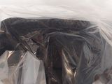 a bag full of plastic bags that are sitting on the ground