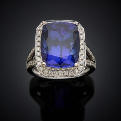 a blue sapphire and diamond ring on a black surface