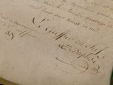 an old book with writing on it sitting on a table