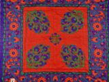 an orange and blue square with a floral design on it
