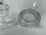 two clear glass vases sitting on a white table