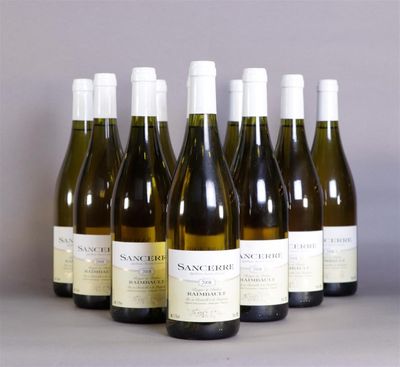 six bottles of wine are lined up in a row on a table