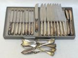 a lot of silverware in a box on the table