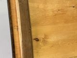 a wooden box with a wooden handle on the floor