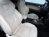 the interior of a car with white leather seats and black trims
