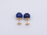 a pair of lapis stone stud earrings on a white surface