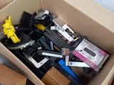 a cardboard box full of electronic equipment on the ground