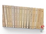 a lot of books that are lined up on a shelf