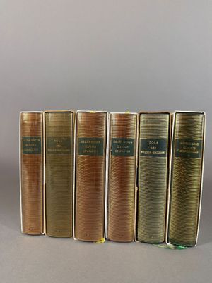 five books are lined up in a row on a table