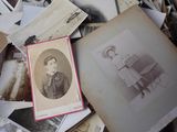 a pile of old photos of a woman sitting on a chair