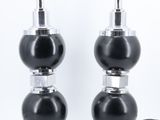 pair of black and chrome table lamps with glass bases