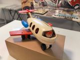 a small toy airplane sitting on top of a cardboard box