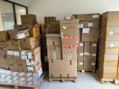 many cardboard boxes stacked on pallets in a warehouse