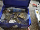 a blue box with tools in it sitting on a table