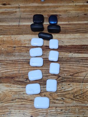 several black and white stones are arranged on a wooden table