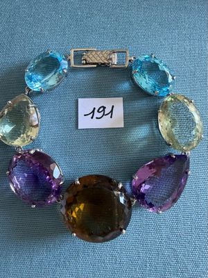 a close up of a bracelet with different colored stones on it