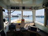 a view of the inside of a boat with a steering wheel
