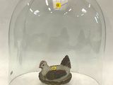 une cloche en verre avec un poulet à l'intérieur