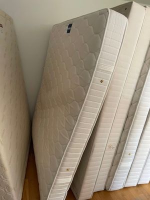 four mattresses stacked on top of each other on the floor