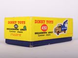 a box of dinky toys sitting on a white surface