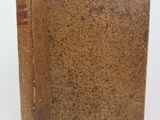 an old book sitting on top of a table next to a white background