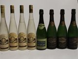 several bottles of wine are lined up in a row on a table