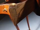 a wooden desk with a brass plate on top