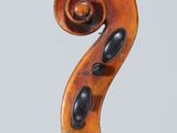 a close up of the back of a violin with a fiddle in the foreground