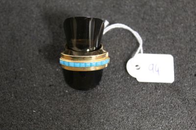 a small black bottle with a gold ring on top of it