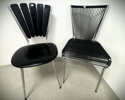 two black chairs sitting next to each other in a room