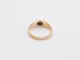 a gold ring with a black stone in the middle