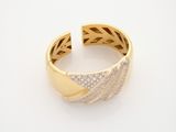 a close up of a gold and diamond ring on a white surface