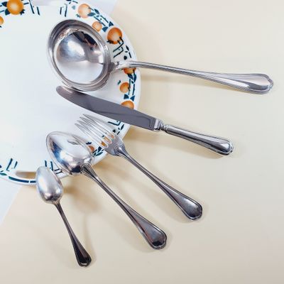 a plate with spoons and silverware on it