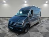 the volkswagen van is parked in a large room with checkered floor